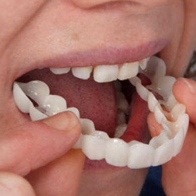 person inserting snap on smile