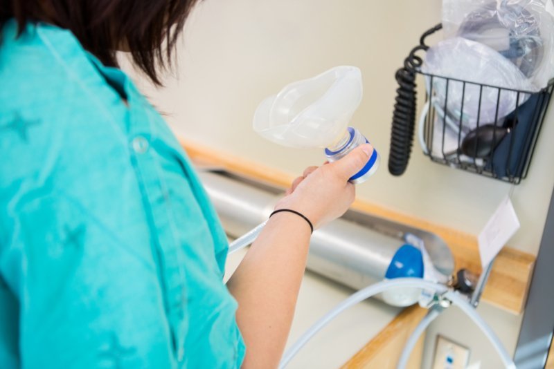 Staff member preparing sedation equipment